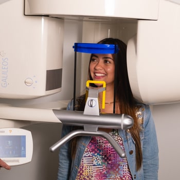 A woman is conducting a 3D X-ray procedure