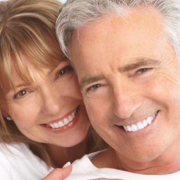 An elderly couple is smiling