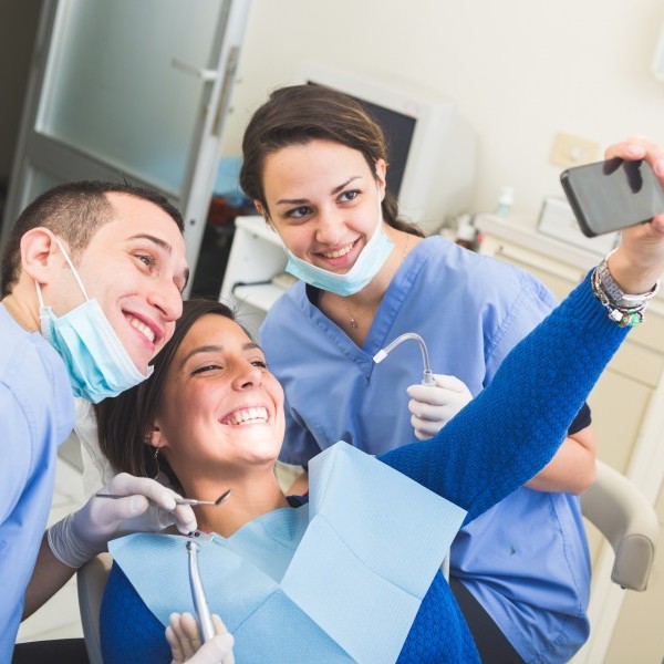 Dental team with a happy patient in a dental chair