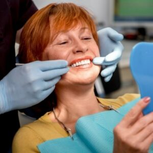Middle aged woman is smiling in a dental chair