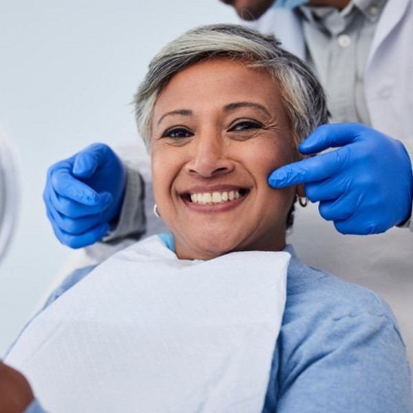 Woman is smiling in a dental chair